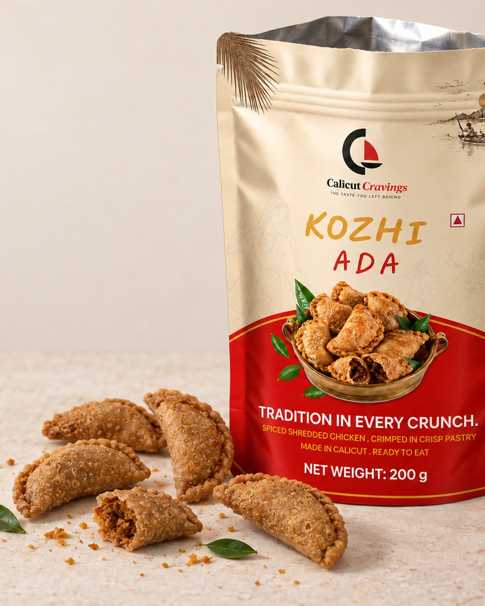 An opened Calicut Cravings Kozhi Ada pack, fried hand-crimped adas spilling onto the counter, one broken to show the chicken.