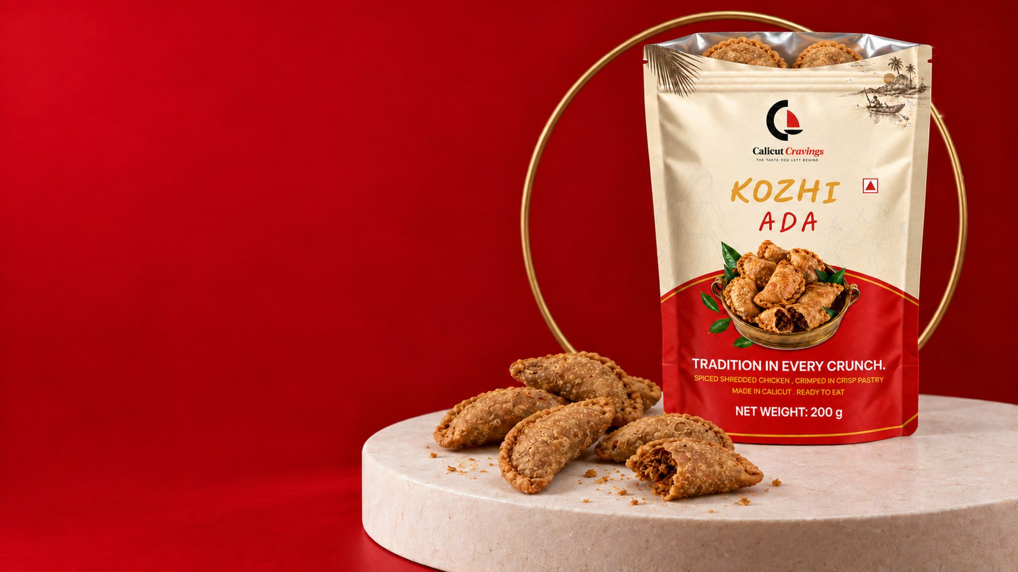 An opened Kozhi Ada pack on a stone plinth against red, fried adas spilling out and one broken to show the filling.