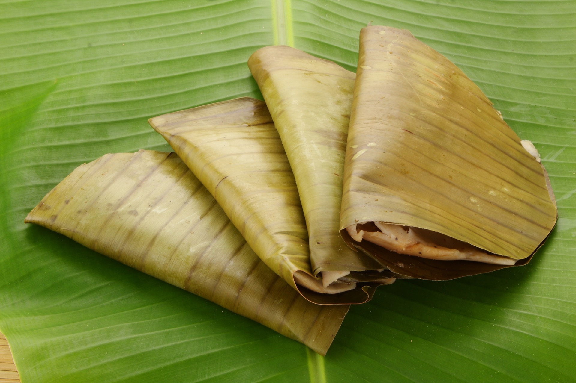 Ela Ada - a banana-leaf-steamed Kerala rice parcel, opened to show the coconut-jaggery filling.