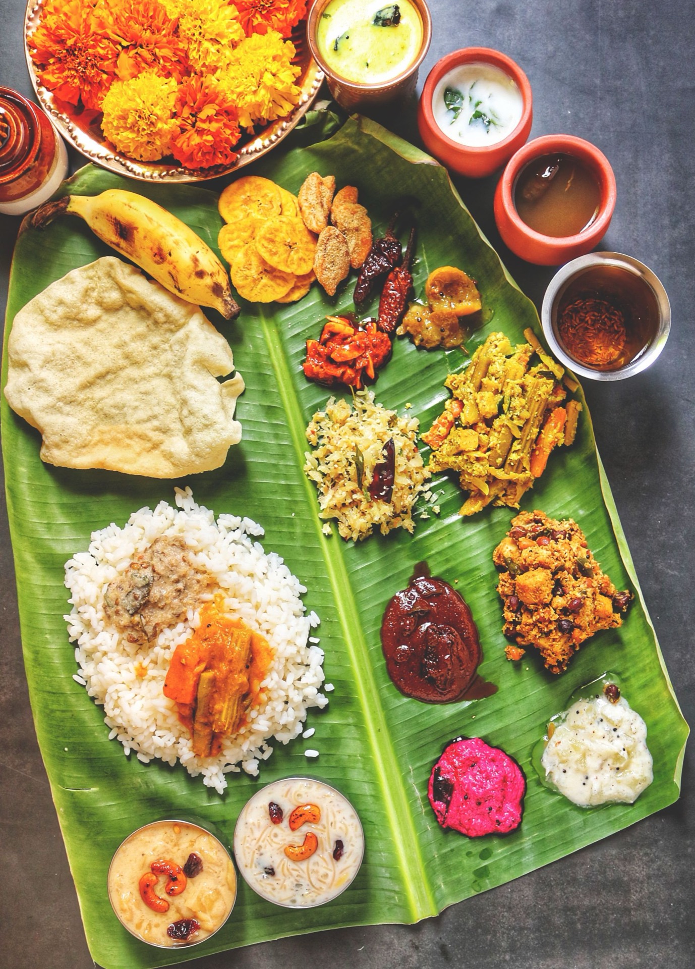A spread of Kerala festival food on a banana leaf - the world of Malabar snacks.