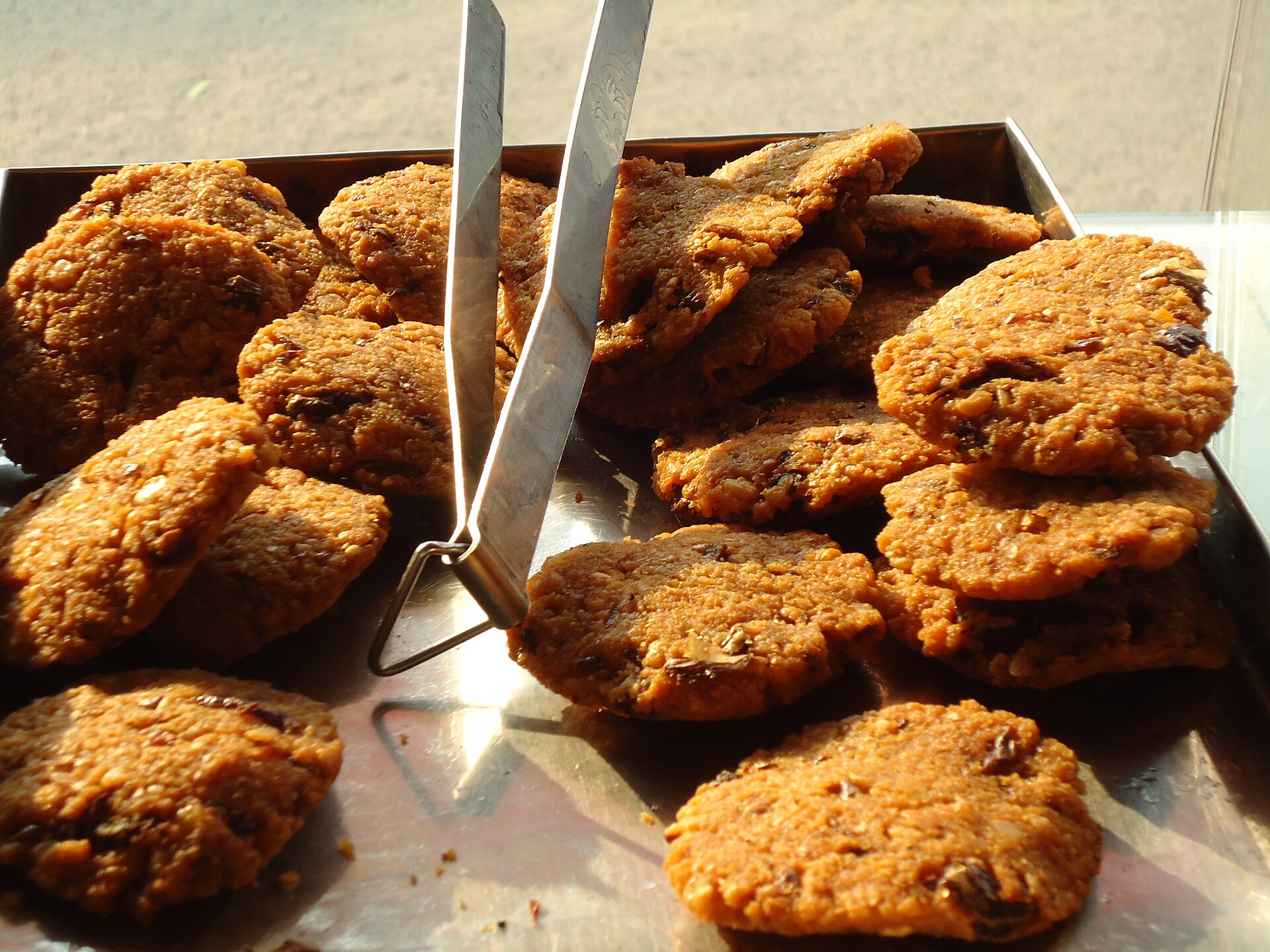 Crisp golden Parippu Vada (Kerala lentil fritters) stacked with curry leaves.